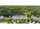 Luxury townhomes overlooking a scenic pond with fountain, surrounded by lush greenery and mature trees at 3616 Bagley Dr, Mount Pleasant, SC 29466