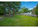 Spacious, well-manicured backyard with lush green grass, mature trees, and privacy fencing provides an ideal outdoor space at 406 S Gum St, Summerville, SC 29483