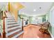 Cozy basement area with functional kitchenette, stairs, and hardwood flooring at 406 S Gum St, Summerville, SC 29483
