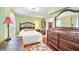 Comfortable bedroom with a large bed, wood furniture, and a walk-in closet at 406 S Gum St, Summerville, SC 29483