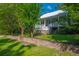 Charming two-story home with a brick foundation, complemented by mature trees and a lush green lawn, providing curb appeal at 406 S Gum St, Summerville, SC 29483
