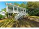 Charming home with a large front porch, lush landscaping, and inviting curb appeal at 406 S Gum St, Summerville, SC 29483