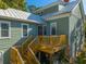 Charming home exterior features a wooden deck, metal roof, and attractive light green siding at 406 S Gum St, Summerville, SC 29483