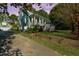 Charming two-story home with a spacious front porch and well-manicured lawn, perfect for outdoor living at 406 S Gum St, Summerville, SC 29483