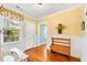 Cozy foyer with a wooden bench, wainscoting, hardwood floors, and natural light at 406 S Gum St, Summerville, SC 29483