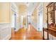 Hallway featuring hardwood floors, white trim, and access to multiple rooms at 406 S Gum St, Summerville, SC 29483