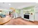 Cozy kitchen featuring wood flooring, white cabinets, and an adjacent living area at 406 S Gum St, Summerville, SC 29483
