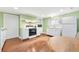 Cozy kitchen with white cabinets, matching appliances, and wood flooring at 406 S Gum St, Summerville, SC 29483
