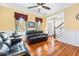 Bright living room with hardwood floors, wainscoting and ample seating at 406 S Gum St, Summerville, SC 29483