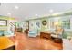 Spacious living room with hardwood floors, ample seating, and large windows at 406 S Gum St, Summerville, SC 29483