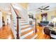 Inviting living room featuring a staircase, ceiling fan and hardwood floors at 406 S Gum St, Summerville, SC 29483