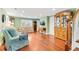 Inviting living room featuring hardwood floors, light green walls, and comfortable seating at 406 S Gum St, Summerville, SC 29483