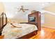 Bright bedroom showcasing hardwood floors, ceiling fan, TV and stylish nautical-themed bedding at 406 S Gum St, Summerville, SC 29483