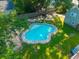 An in-ground pool in a lush backyard offers a refreshing retreat in a beautiful outdoor setting, complemented by mature trees at 406 S Gum St, Summerville, SC 29483