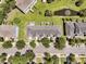 Aerial view of the houses on the street with manicured lawns and a pond at 4060 Hartland St, Charleston, SC 29414