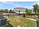 Fenced backyard with grass and walkway with an air conditioning unit on one side at 4060 Hartland St, Charleston, SC 29414