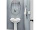Pedestal sink and oval mirror create a charming powder room aesthetic at 4060 Hartland St, Charleston, SC 29414
