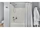 Clean and bright bathroom with a shower-tub, a shower curtain, towel racks, and white wall paint at 4060 Hartland St, Charleston, SC 29414
