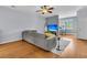 Well-lit living room showcasing hardwood floors, a large sectional, and an open layout to the dining area at 4060 Hartland St, Charleston, SC 29414