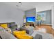 Cozy living room with a gray sectional, hardwood floors, and bright natural light streaming through the windows at 4060 Hartland St, Charleston, SC 29414