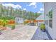 Well-maintained backyard with stone patio, lush green surroundings, and BBQ at 4314 Cotton Flat Rd, Summerville, SC 29485