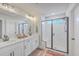 Bright bathroom with a double vanity, sleek fixtures, and a glass-enclosed shower with built-in seat at 4314 Cotton Flat Rd, Summerville, SC 29485