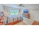 Spacious bedroom with a cozy bed, view of the outdoors, and a sleek dresser with a mounted TV at 4314 Cotton Flat Rd, Summerville, SC 29485