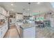Open-concept kitchen and dining area with an island and a rustic dining table, perfect for modern living at 4314 Cotton Flat Rd, Summerville, SC 29485