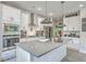 Bright kitchen with stainless steel appliances, gray countertops, and an island with a sink, ideal for cooking at 4314 Cotton Flat Rd, Summerville, SC 29485
