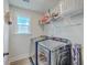 Efficient laundry room equipped with modern appliances, shelving, and natural light for a convenient space at 4314 Cotton Flat Rd, Summerville, SC 29485