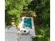 Aerial view of a modern pool and deck area surrounded by trees and adjacent to a stylish home at 441 Elfes Field Ln, Charleston, SC 29492