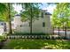 A beautifully landscaped backyard features a basketball court next to a charming white home at 441 Elfes Field Ln, Charleston, SC 29492