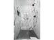 Modern bathroom shower featuring white and black marble-patterned tiles and dark fixtures behind a partial glass door at 441 Elfes Field Ln, Charleston, SC 29492