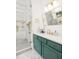 Stylish bathroom with a green vanity, modern fixtures, and a walk-in shower with glass door at 441 Elfes Field Ln, Charleston, SC 29492