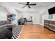 A bright bedroom with hardwood floors, comfortable seating, ceiling fan, shutters, and a basketball hoop at 441 Elfes Field Ln, Charleston, SC 29492