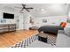 Spacious bedroom featuring hardwood floors, a ceiling fan, a comfortable seating area, and modern decor at 441 Elfes Field Ln, Charleston, SC 29492