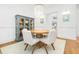 Bright dining area featuring a round table, upholstered chairs, and a display cabinet at 441 Elfes Field Ln, Charleston, SC 29492