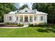 Stunning white brick home with a classic design, featuring a welcoming porch with columns and shutters at 441 Elfes Field Ln, Charleston, SC 29492