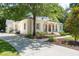 Side view of a white brick home showcasing the driveway and well-maintained lawn at 441 Elfes Field Ln, Charleston, SC 29492