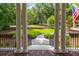 Covered front porch framed by columns, providing a scenic view of the landscaped front yard at 441 Elfes Field Ln, Charleston, SC 29492