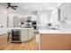 Open kitchen featuring white cabinetry, stainless steel appliances, and a convenient wine refrigerator at 441 Elfes Field Ln, Charleston, SC 29492