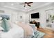 Bright bedroom showcasing plush bedding, ceiling fan, and a view to the ensuite bath at 441 Elfes Field Ln, Charleston, SC 29492