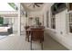 A covered outdoor patio with a dining area, ceiling fan, and a built-in grill, perfect for entertaining guests at 441 Elfes Field Ln, Charleston, SC 29492