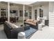 Covered outdoor patio with comfortable seating, ceiling fan, and dining area, perfect for relaxing and entertaining at 441 Elfes Field Ln, Charleston, SC 29492