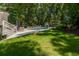 Beautiful backyard pool area surrounded by lush greenery and lounge chairs for relaxation at 441 Elfes Field Ln, Charleston, SC 29492