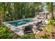 Lush backyard pool with lounge chairs, and tropical landscaping, offering a private oasis at 441 Elfes Field Ln, Charleston, SC 29492
