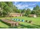 Spacious backyard with a garden bed and outbuildings, perfect for outdoor activities and enjoying nature at 4428 Maple Ridge Rd, Walterboro, SC 29488