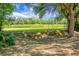 Large backyard with a swing set, slide, treehouse, and lush greenery at 4428 Maple Ridge Rd, Walterboro, SC 29488