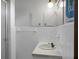 Bright bathroom featuring white tile, ample cabinet space, and a well-lit vanity at 4428 Maple Ridge Rd, Walterboro, SC 29488