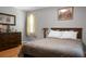 Warm bedroom interior with a full bed, dark wood dresser and wood floors at 4428 Maple Ridge Rd, Walterboro, SC 29488